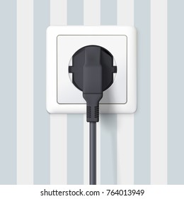 Black plug inserted in a wall socket on backdrop of wall with wallpaper with stripes. The plug is plugged into the power lines with electric cord. Icon of device for connecting electrical appliances