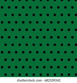 Black polka dots on green background