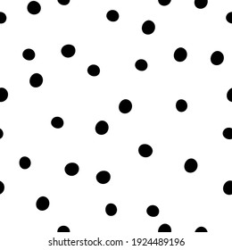 Black polka dots on white background. Seamless doodle pattern with chaotic dots.