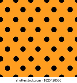 Black polka dots seamless pattern on orange background for Halloween wallpaper, wrapping paper,fashion print etc.