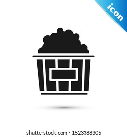 Black Popcorn in cardboard box icon isolated on white background. Popcorn bucket box.  Vector Illustration