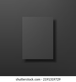 Black poster mockup hanging on black wall.