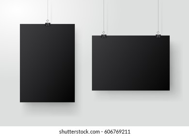 Black posters hanging on binder. Grey wall with mock up empty paper blank. Layout mockup. Vertical and horizontal template sheet