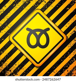 Black Pretzel icon isolated on yellow background. German comfort food pastry. Oktoberfest festival. Warning sign. Vector