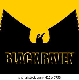 Black raven on yellow background. Big Bird. Spread wings. Silhouette Crow of  in sunset
