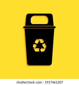 Black Recycle bin with recycle symbol icon isolated on yellow background. Trash can icon. Garbage bin sign. Recycle basket sign. Long shadow style. Vector.