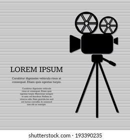 Black retro vector movie camera on grey background