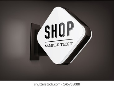 black rhombus signboard with rounded corners, hanging on a wall