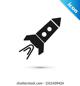 Black Rocket ship with fire icon isolated on white background. Space travel.  Vector Illustration