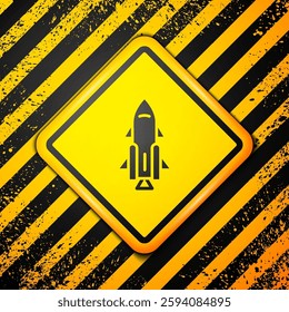 Black Rocket ship with fire icon isolated on yellow background. Space travel. Warning sign. Vector