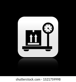 Black Scale with cardboard box icon isolated on black background. Logistic and delivery. Weight of delivery package on a scale. Silver square button. Vector Illustration