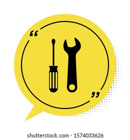 Black Screwdriver and wrench tools icon isolated on white background. Service tool symbol. Yellow speech bubble symbol. Vector Illustration