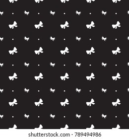 Black seamless pattern with white circles and bows.
