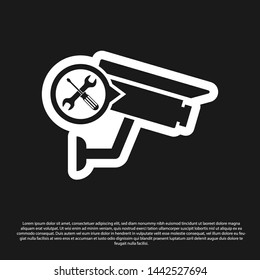 Black Security camera with screwdriver and wrench icon isolated on black background. Adjusting, service, setting, maintenance, repair, fixing.  Vector Illustration