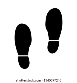 Black shoe prints symbol - Vector of black shoe prints on the white surface with space for text