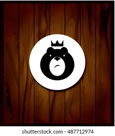 black silhouette bear on background of wooden planks