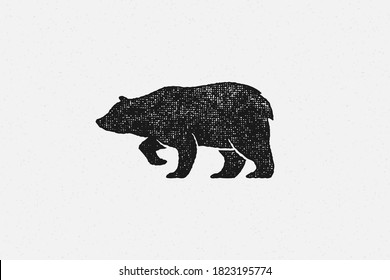 Black silhouette of bear as symbol of wild fauna in nature hand drawn stamp effect vector illustration. Vintage grunge texture on old paper for poster or label decoration.