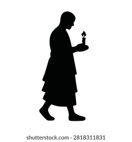 Black silhouette of a buddhist monk walking while holding a burning candle on white background.