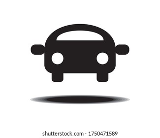 Black silhouette of a car facing forward, above the ground. Windshield and headlights appear as white. Circular black shadow below the car. On a white background.