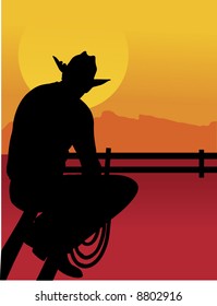 Black silhouette of a cowboy sitting on a fence looking at the sunset