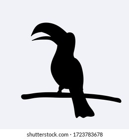 Black silhouette of a cute toucan sitting on branch. Vector illustration