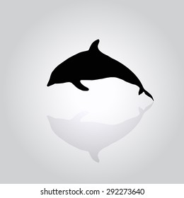 black silhouette of a dolphin jumping on a gray background. Reflection. Space for text below.