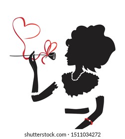 Black silhouette of an elegant girl with a magnificent hairstyle. Loving woman with a string of pearls on her neck, a rose and a red ribbon in the shape of a heart in her hands. Vector image.