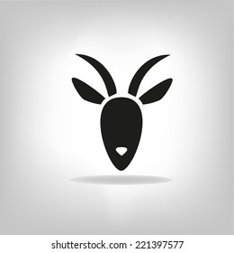 black silhouette of goat on a light background