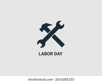 a black silhouette of a hammer crossed with a wrench