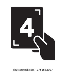 A black silhouette of a hand holding a playing card with the number four