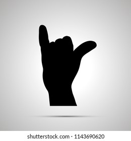 Black silhouette of hand in shaka gesture isolated on white