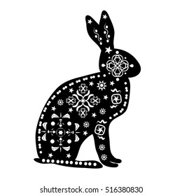 black silhouette of a hare, a rabbit in the old, white ethnic patterns and ornaments of traditional tribes and shamans in Africa, Australian Aborigines, the native tribes of American Indians