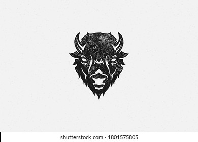 Black silhouette of head of wild buffalo or bison as symbol of nature exploration hand drawn stamp effect vector illustration. Vintage grunge texture on old paper for poster or label decoration.