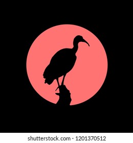 Black silhouette of Hern bird in front of red circle