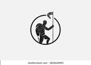 Black Silhouette Hiker Putting Flag On Top Mountain Trip In Highlands Hand Drawn Stamp Effect Vector Illustration. Vintage Grunge Texture On Old Paper For Poster Or Label Decoration.