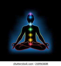 Black silhouette of a human in lotus position with colorful chakras