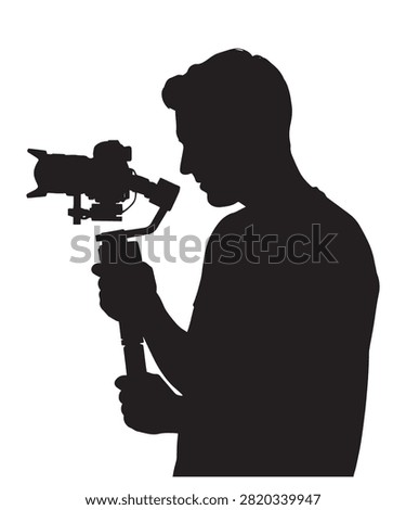 Black silhouette of a man holding a modern camera stabilizer gimbal to record smooth video footage outdoors.