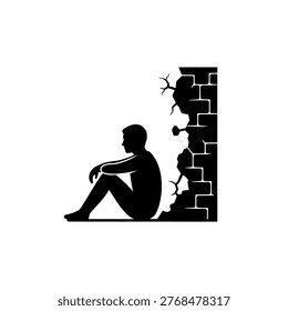 A black silhouette of a man sitting on the floor next to a cracked and broken brick wall.