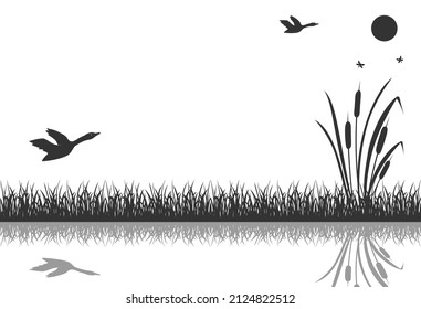 The black silhouette of marsh grass with flying ducks is reflected in the water.