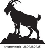Black silhouette of a mountain goat standing on a rock