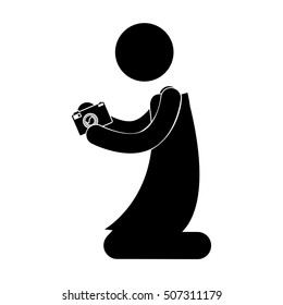 black silhouette person kneeling with camera