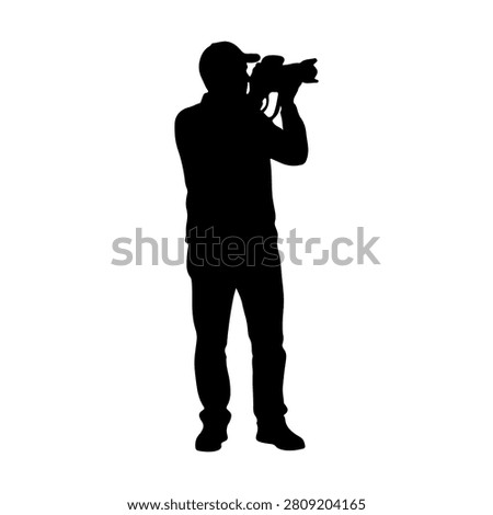 Black silhouette of a photographer capturing a shot with a camera, emphasizing the art of photography and visual storytelling.