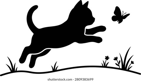 Black silhouette of a playful kitten jumping for a butterfly