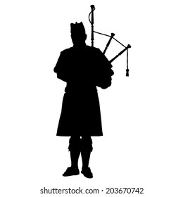 A black silhouette of a Scottish piper playing the bagpipes