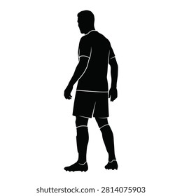 A black silhouette of a soccer player standing and looking away, representing a moment of tactical observation or focus on the field during a professional game.