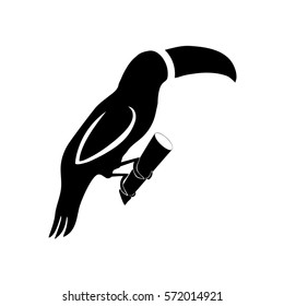 The black silhouette of a toucan bird sitting on a branch. Toucan is depicted in profile. Visible tail, beak, legs.