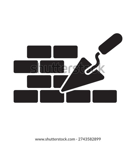 Black silhouette of a trowel applying mortar to a brick wall