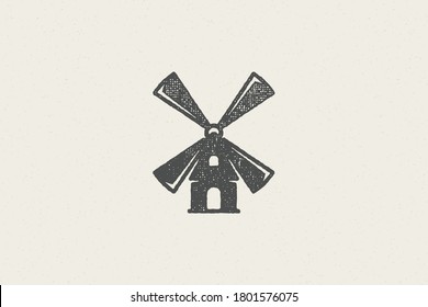 Black silhouette of vintage windmill in countryside designed for grain farming industry hand drawn stamp effect vector illustration. Grunge texture old paper for packaging design or label decoration.