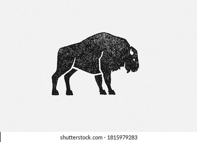 Black silhouette wild buffalo as symbol of wildlife in nature hand drawn stamp effect vector illustration. Vintage grunge texture on old paper for poster or label decoration.