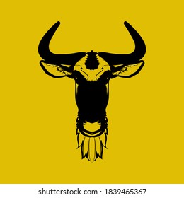 Black silhouette of a wildebeest head on yellow background. Vector illustration.